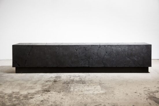 Carbon M (bench): mat black sculpture bench by British artist Tom Price in the shape of a cuboid made of coal.