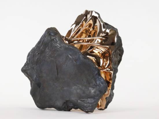 Sleeping Beauty: boulder-like sculpture with golden polished bronze Interior by Romain Langlois