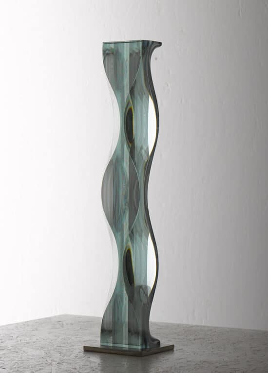 M.180603: vertical glass sculpture by Japanese contemporary artist Toshio Iezumi, which combines convex and concave forms to create a motion-like effect.