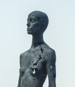 The Presence of Absence – Female: life-size statue of a standing naked woman by British artist Tom Price, made with coal and epoxy resin, inspired by the petrified bodies of Vesuvius victims found in Pompeii.