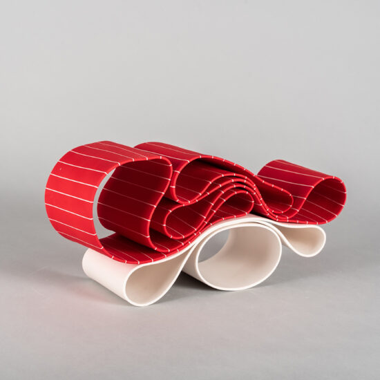 Folding in motion 8: ribbon-like ceramic sculpture by Simcha Even-Chen composed of two intertwined parts, each made with paper porcelain. One part is white and the other one is painted in bright red with white stripes.